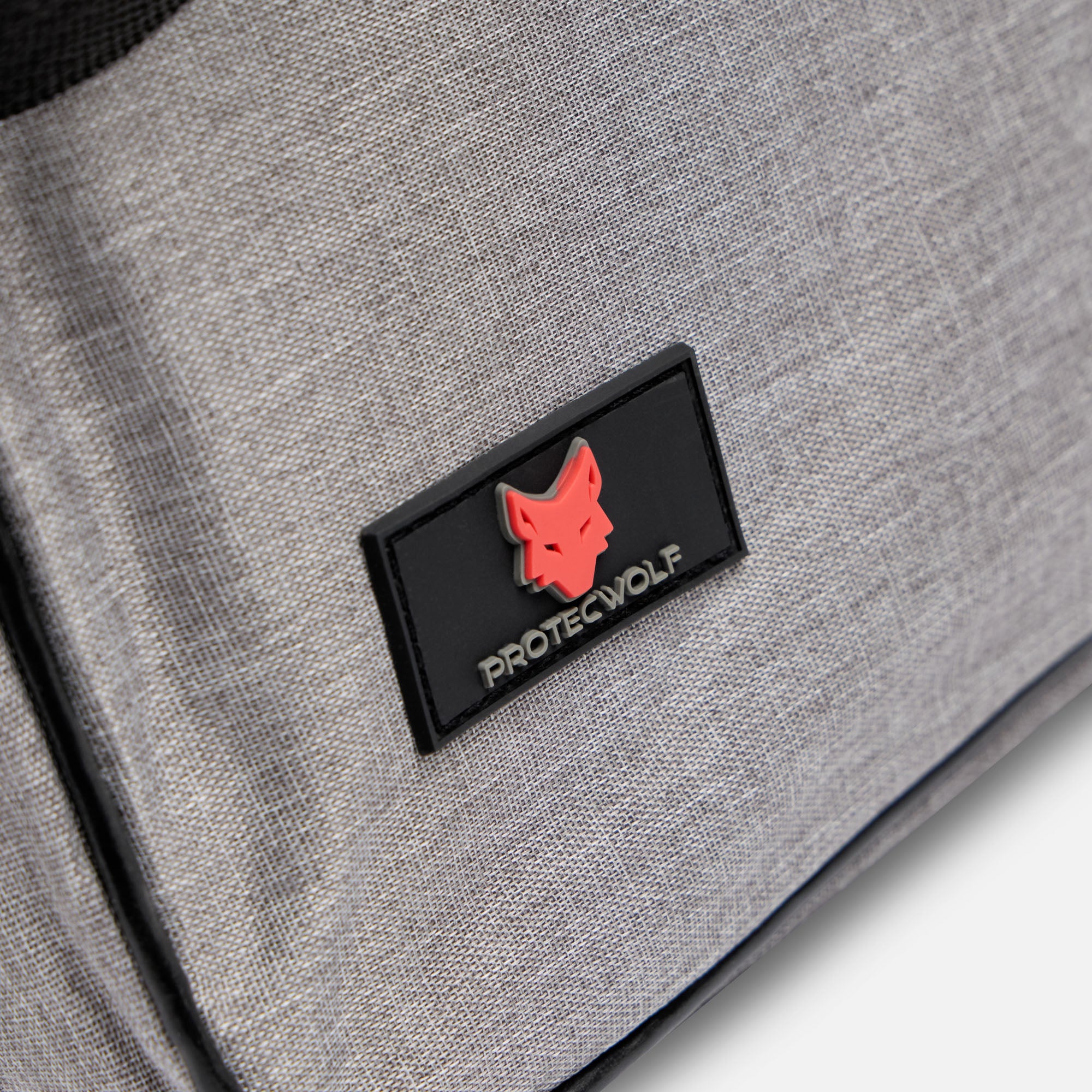 Gray bag with a black patch featuring a red wolf logo and 'ProtecWolf' text.