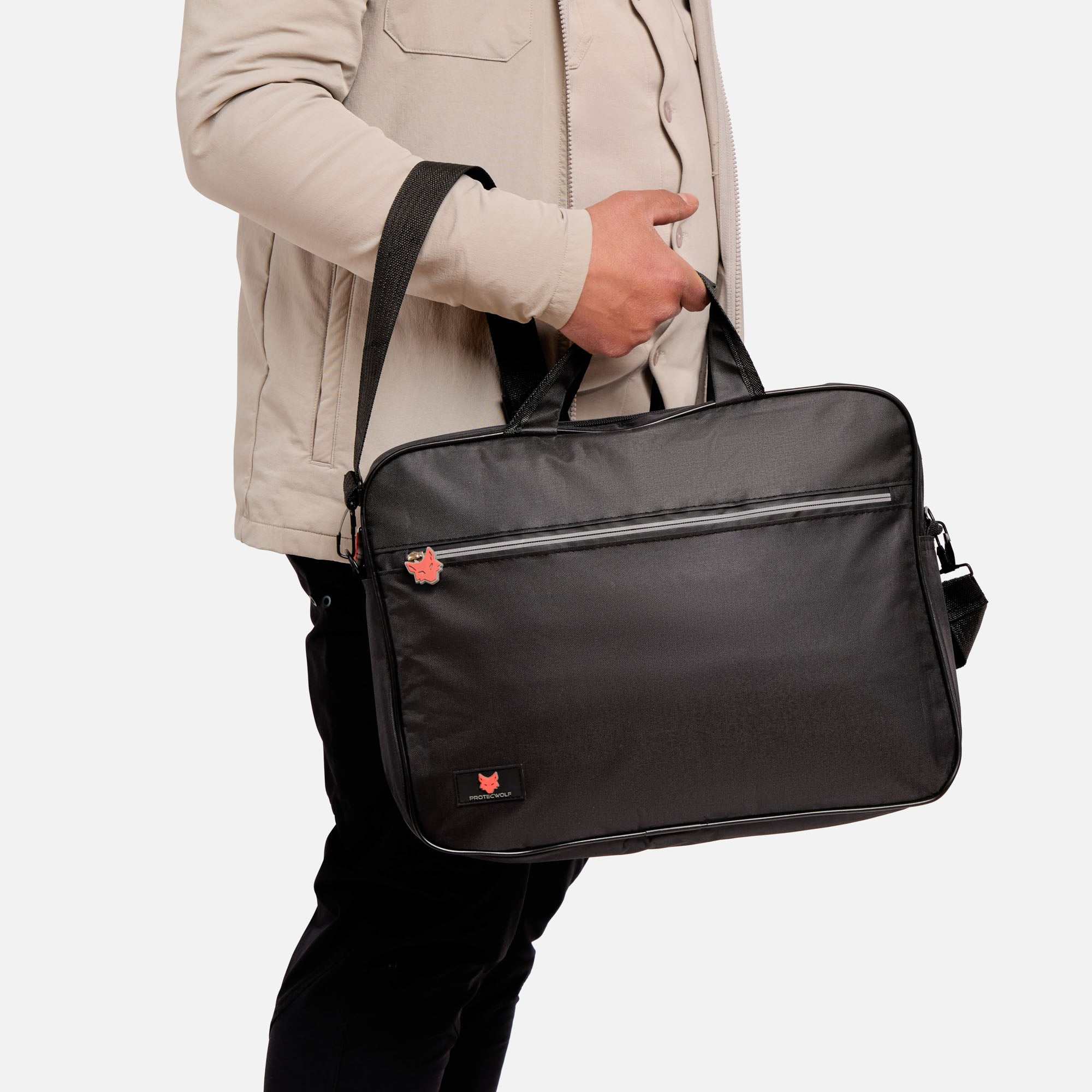 Person holding a black shoulder bag on a white background