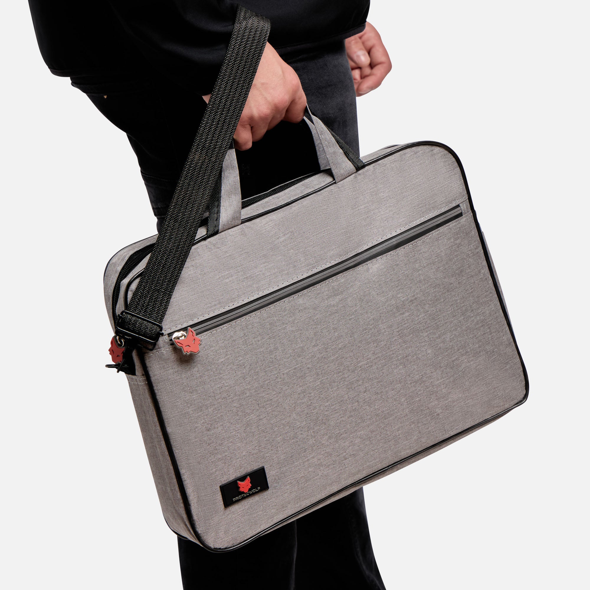 Person holding a gray laptop bag with a black strap on a white background