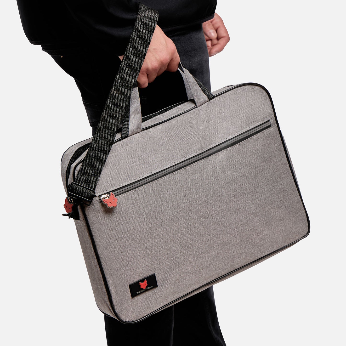 Person holding a gray laptop bag with a black strap on a white background