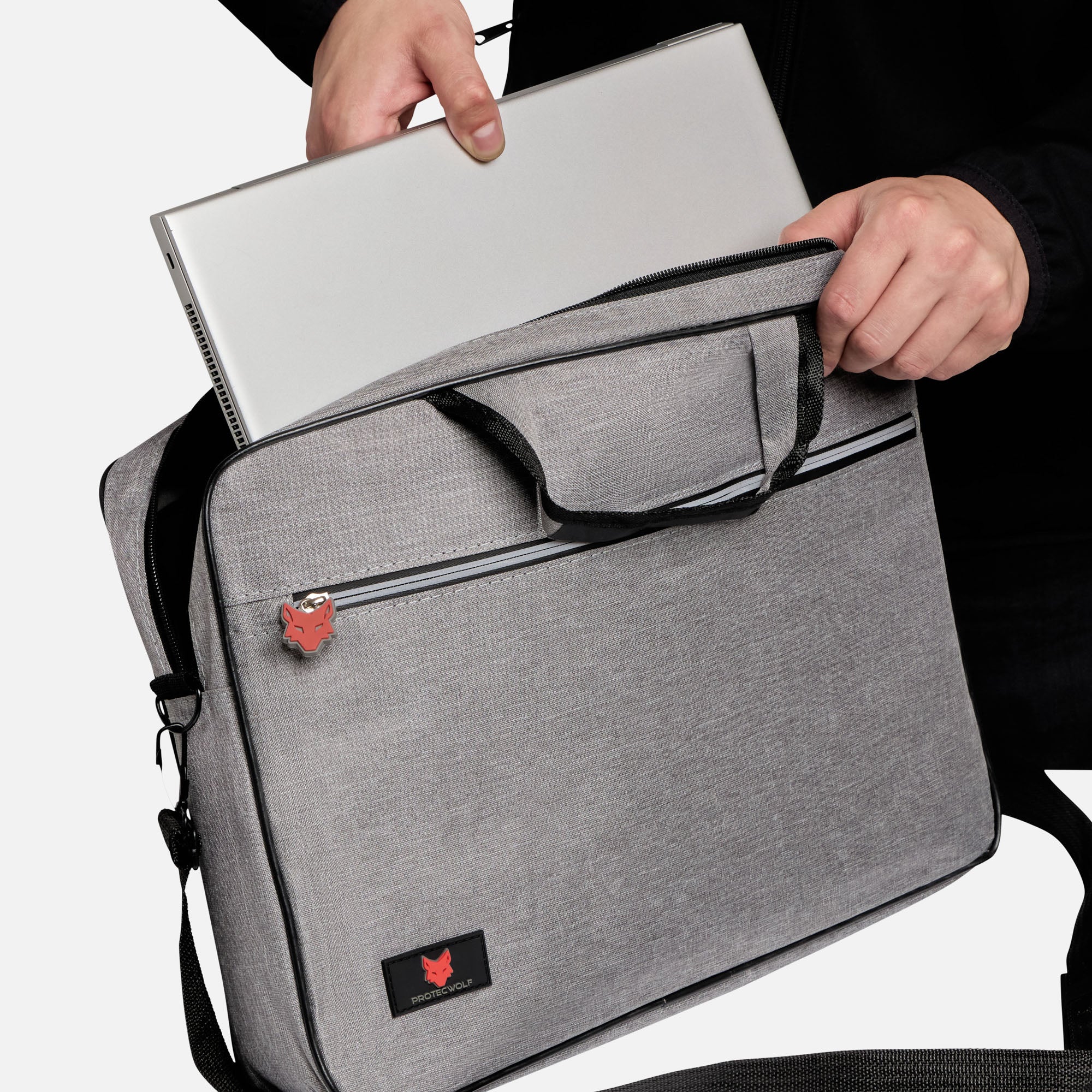 Person holding a gray laptop bag with a brand logo on a white background