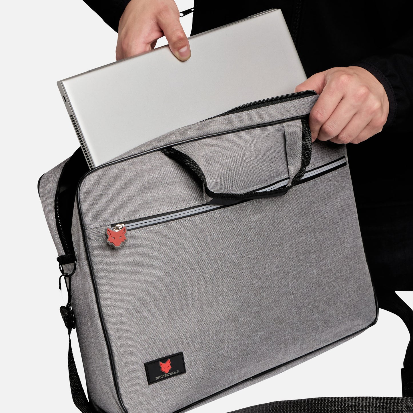 Person holding a gray laptop bag with a brand logo on a white background