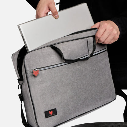 Person holding a gray laptop bag with a brand logo on a white background