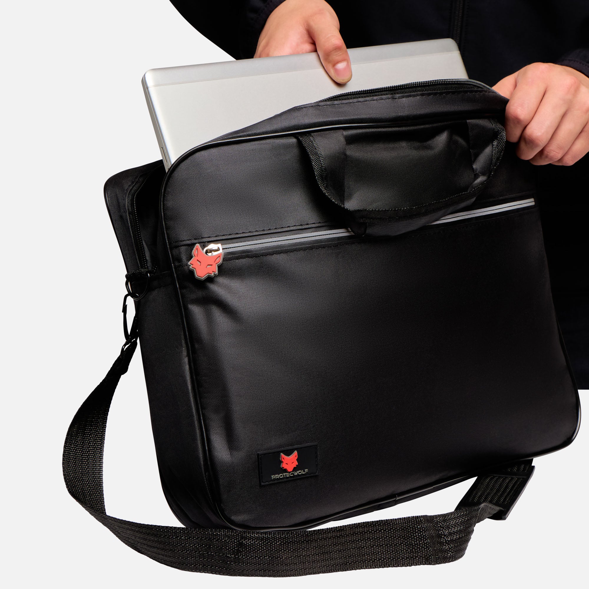 Black laptop bag with a visible brand logo held by a person on a white background