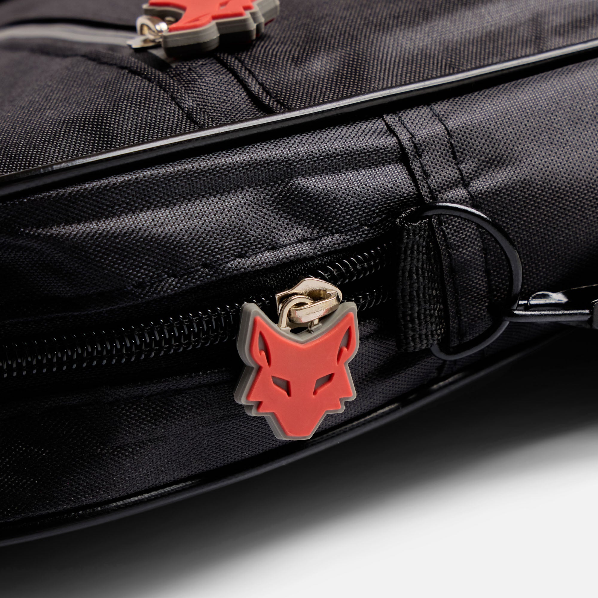 Black bag with red and grey wolf zip attached