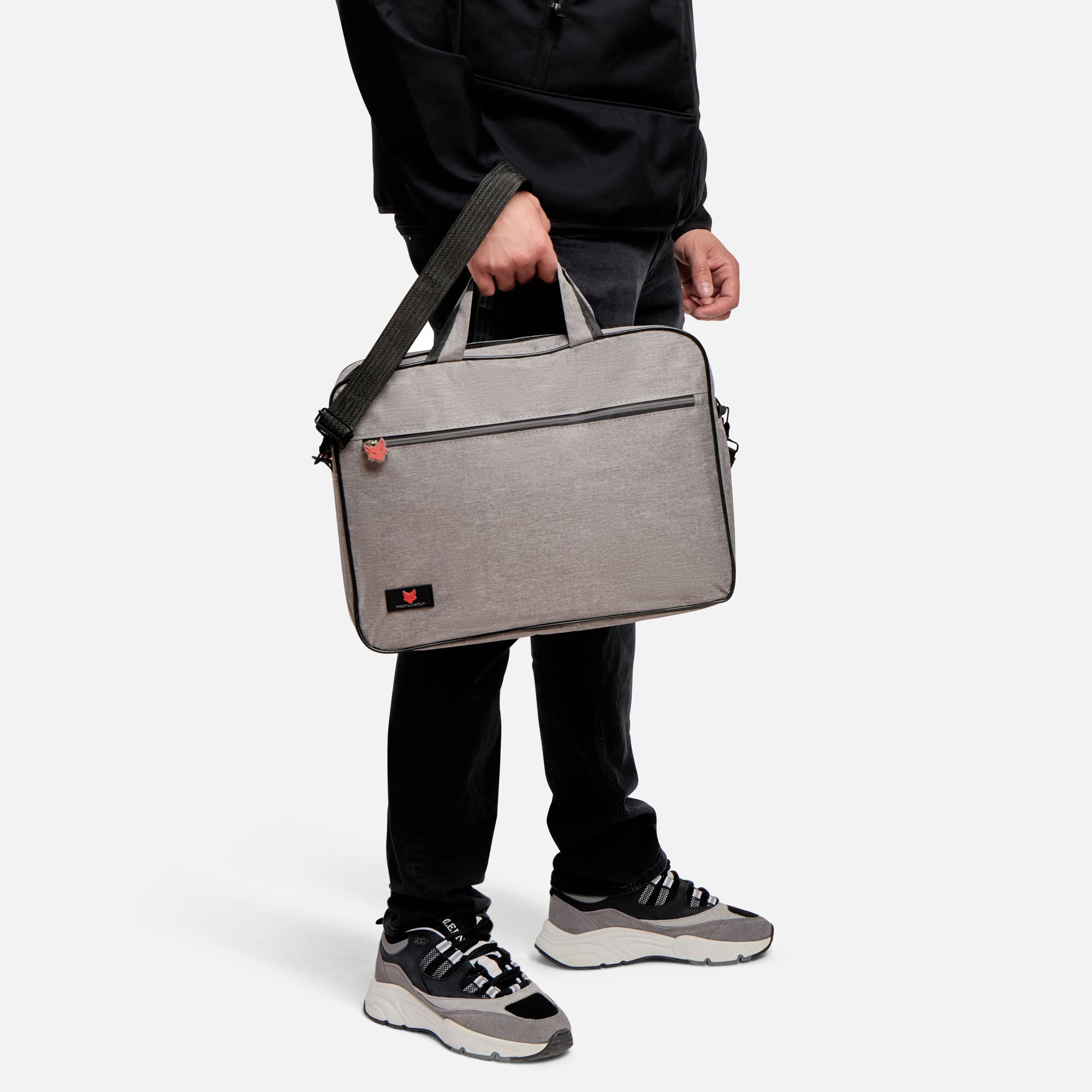 Person holding a gray briefcase against a white background