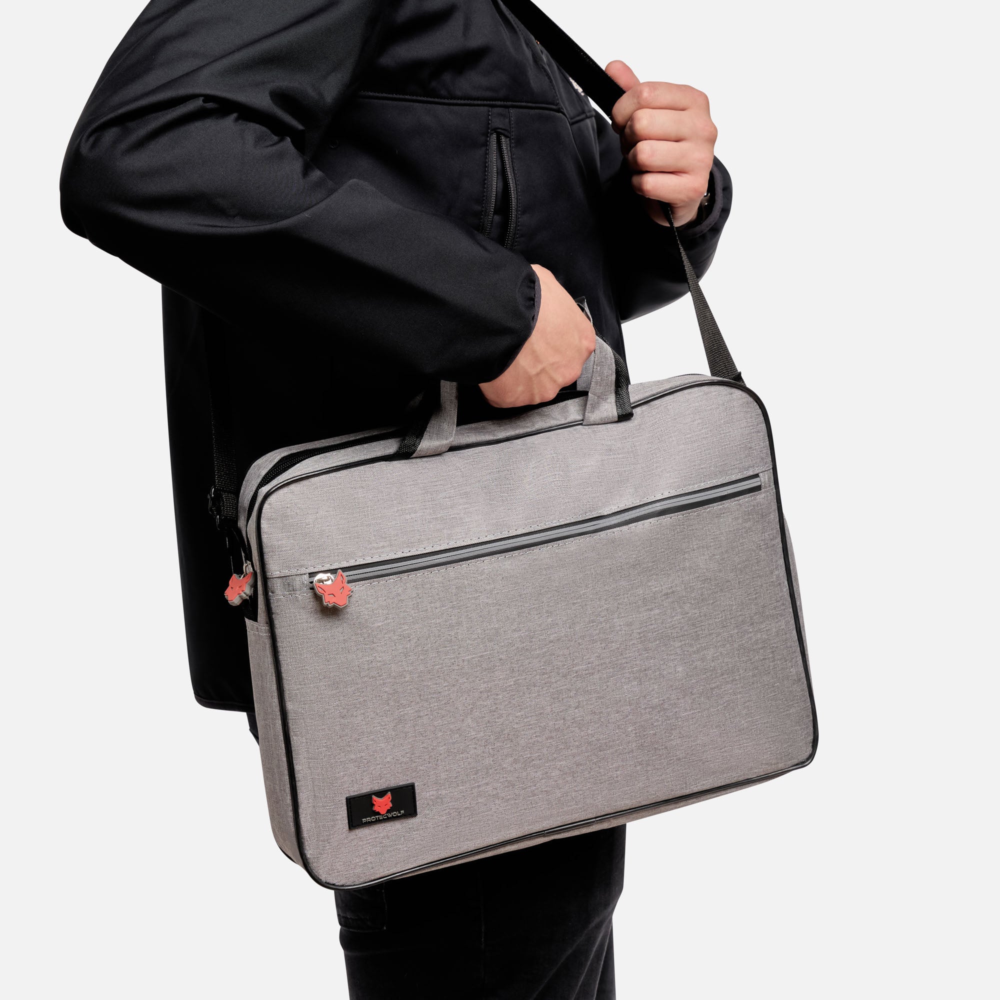 Person holding a gray laptop bag with a visible brand logo on a white background